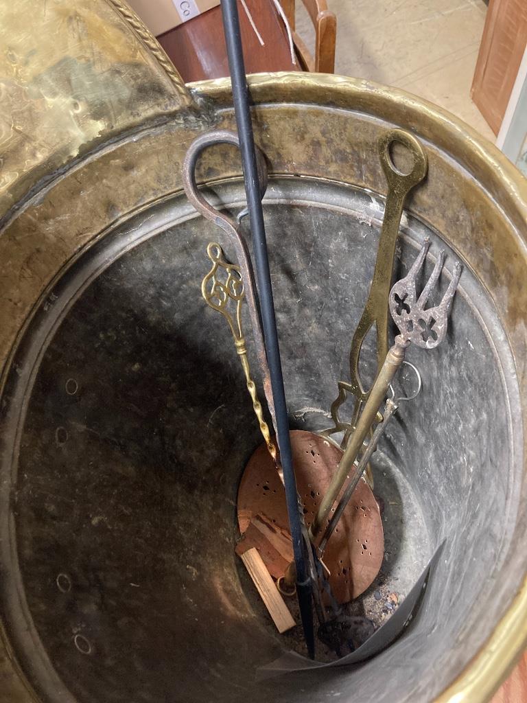 A 19th century embossed brass grape hod, height 83cm together with assorted fire irons etc.